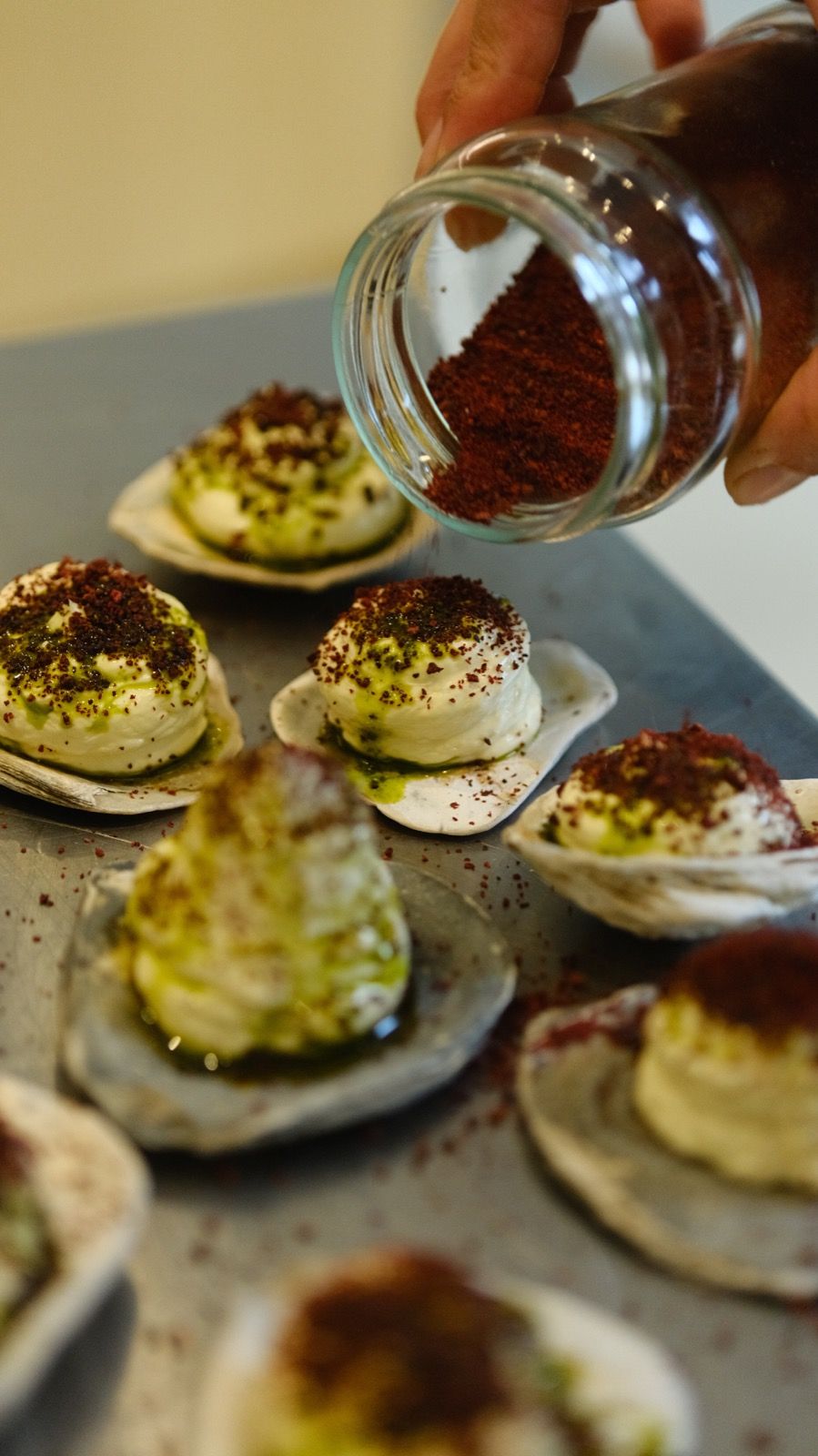Sprinkling sumac over individual starters