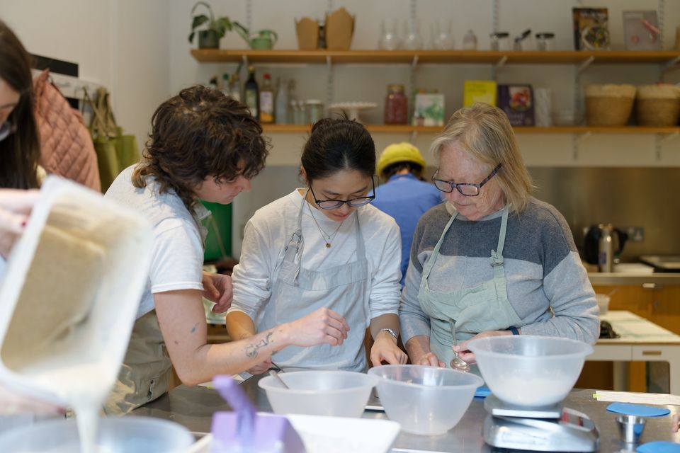 Participants mixing ingredients together at a festival workshop